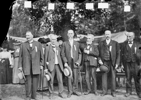 Alexander Beaubien, Albert Lenmersaid, James Sinclair, W. H. Gale, George C. Foote and Samuel Flanders standing for portrait under a tree at an Old Settlers Picnic - Chicago Daily News, Inc.