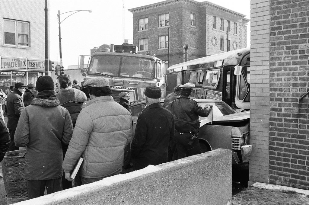 Bystanders investigate an accident involving a public transit bus - Chicago Sun-Times