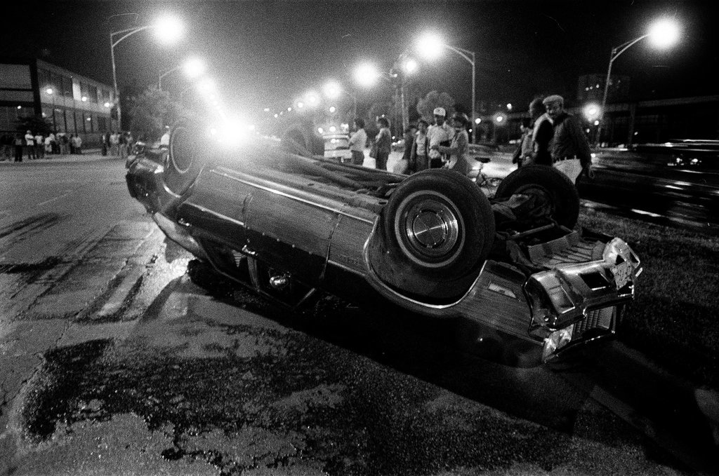 Police and bystanders investigate a car accident - Chicago Sun-Times
