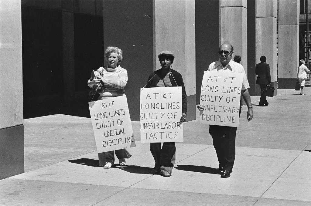Three protesters stand outside the Bell Telephone Company - Chicago Sun-Times
