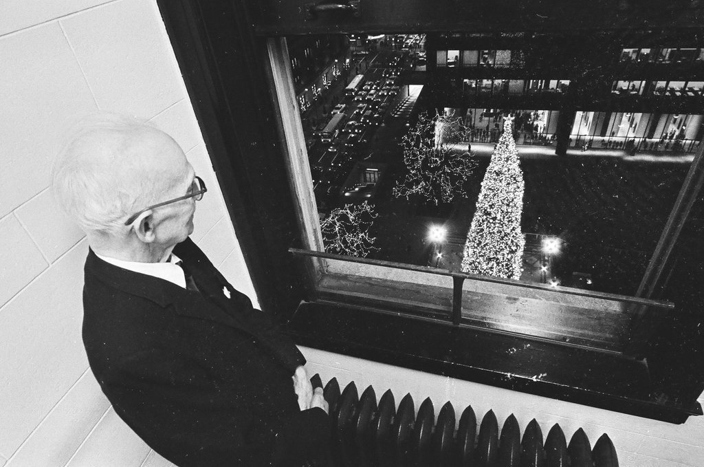 Man looking at the Civic Center Christmas tree from his window - Chicago Sun-Times