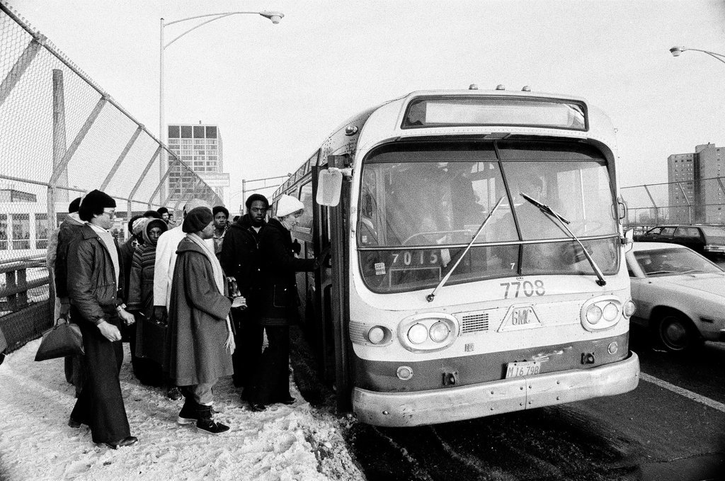 People waiting to board busses - Chicago Sun-Times