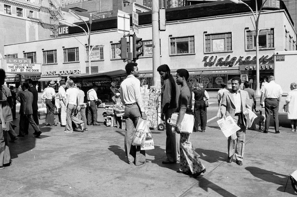 People selling Islamic newspaper on a street corner - Chicago Sun-Times