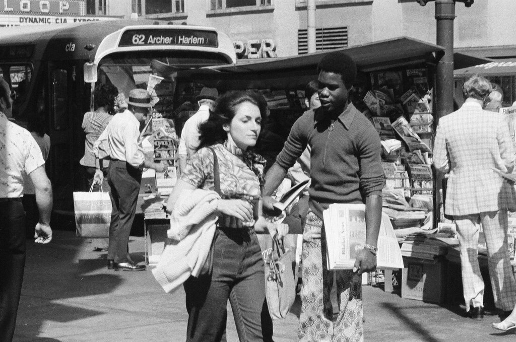 People selling Islamic newspaper on a street corner - Chicago Sun-Times