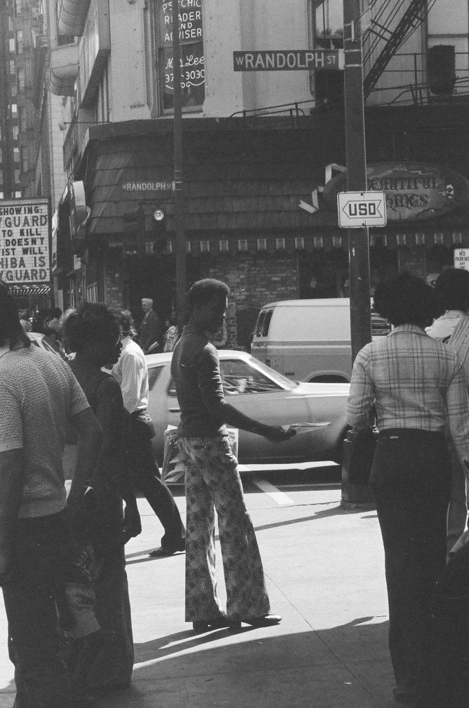 People selling Islamic newspaper on a street corner - Chicago Sun-Times