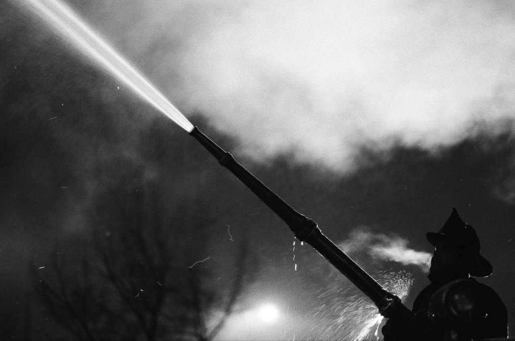 Firefighters using hoses on apartment building - Chicago Sun-Times