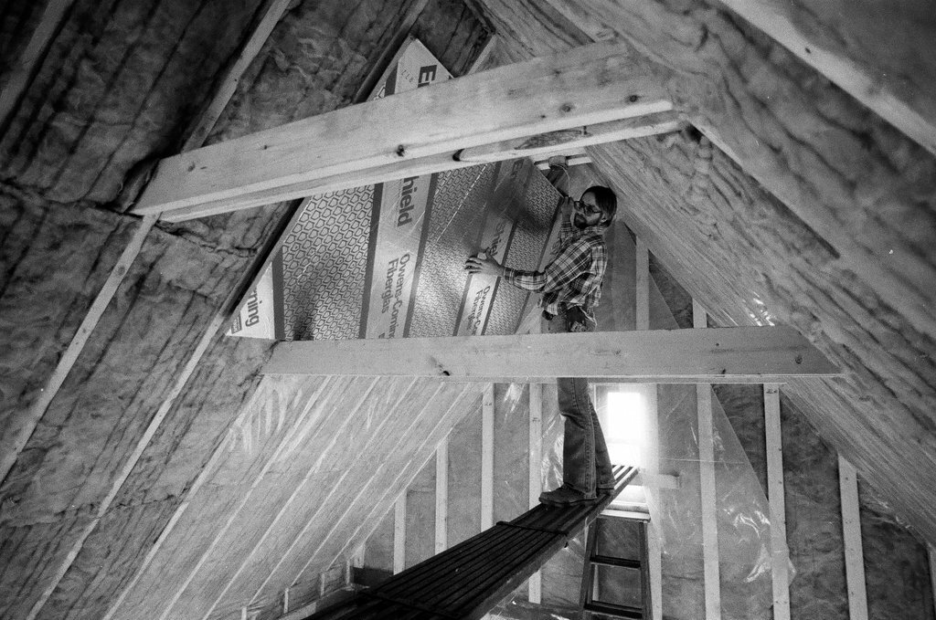 Workers install insulation in a house - Gene Pesek for Chicago Sun-Times