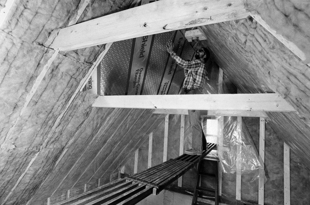 Workers install insulation in a house - Gene Pesek for Chicago Sun-Times