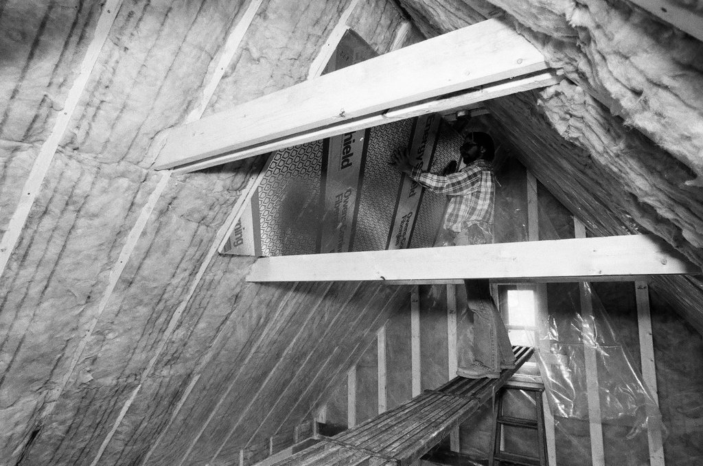 Workers install insulation in a house - Gene Pesek for Chicago Sun-Times