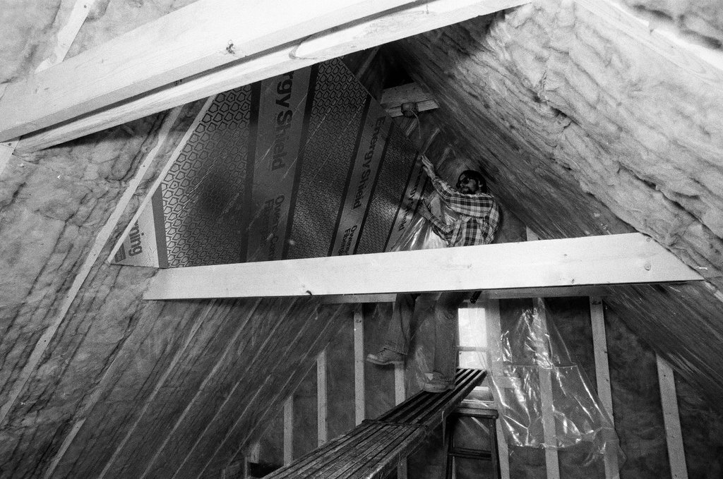 Workers install insulation in a house - Gene Pesek for Chicago Sun-Times