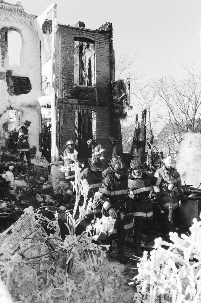 Firemen retrieve bodies from house fire - Al Podgorski for Chicago Sun-Times