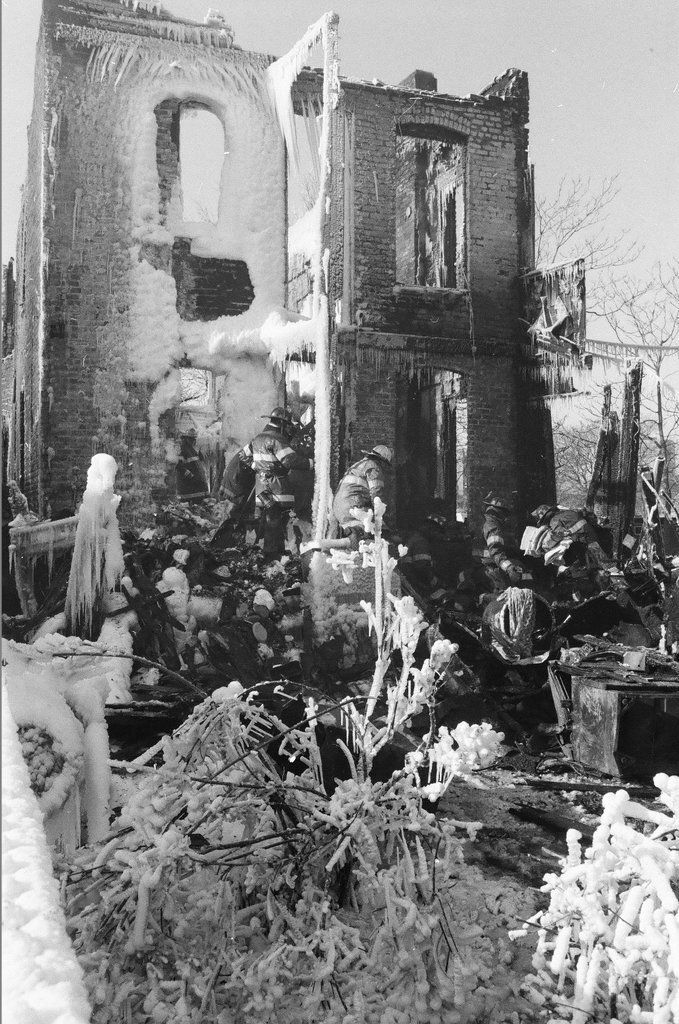 Firemen retrieve bodies from house fire - Al Podgorski for Chicago Sun-Times