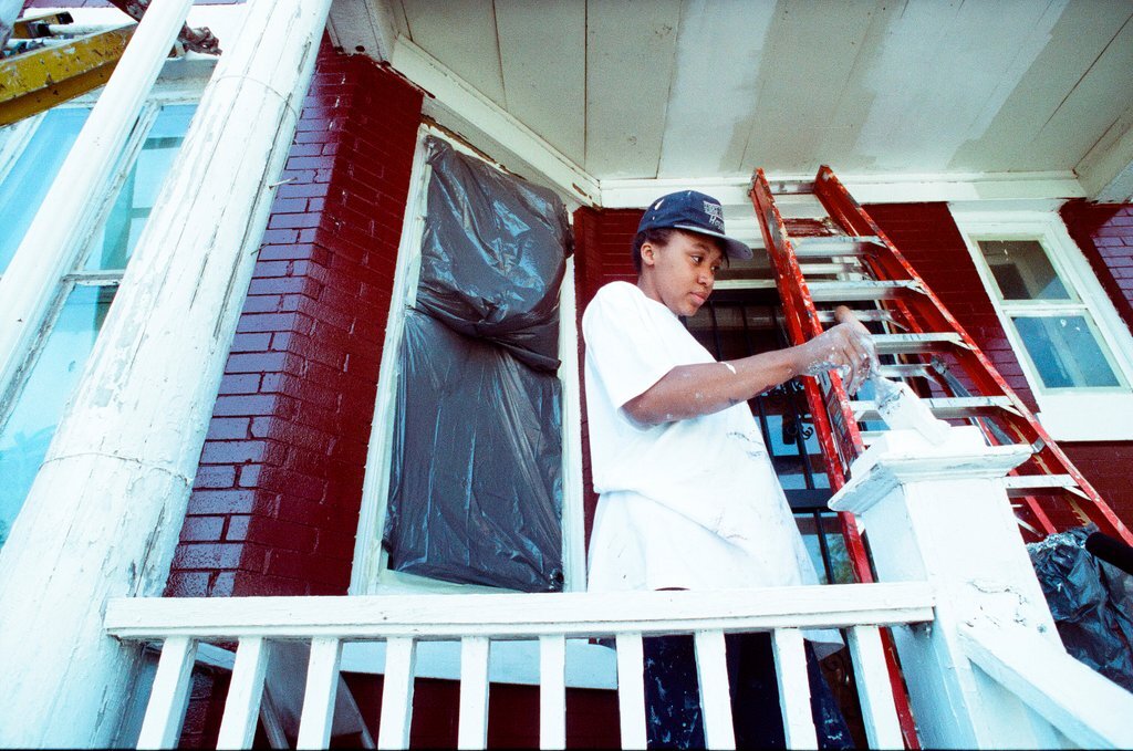 Teens from Look to the Future program paint a porch - Jon Sall for Chicago Sun-Times