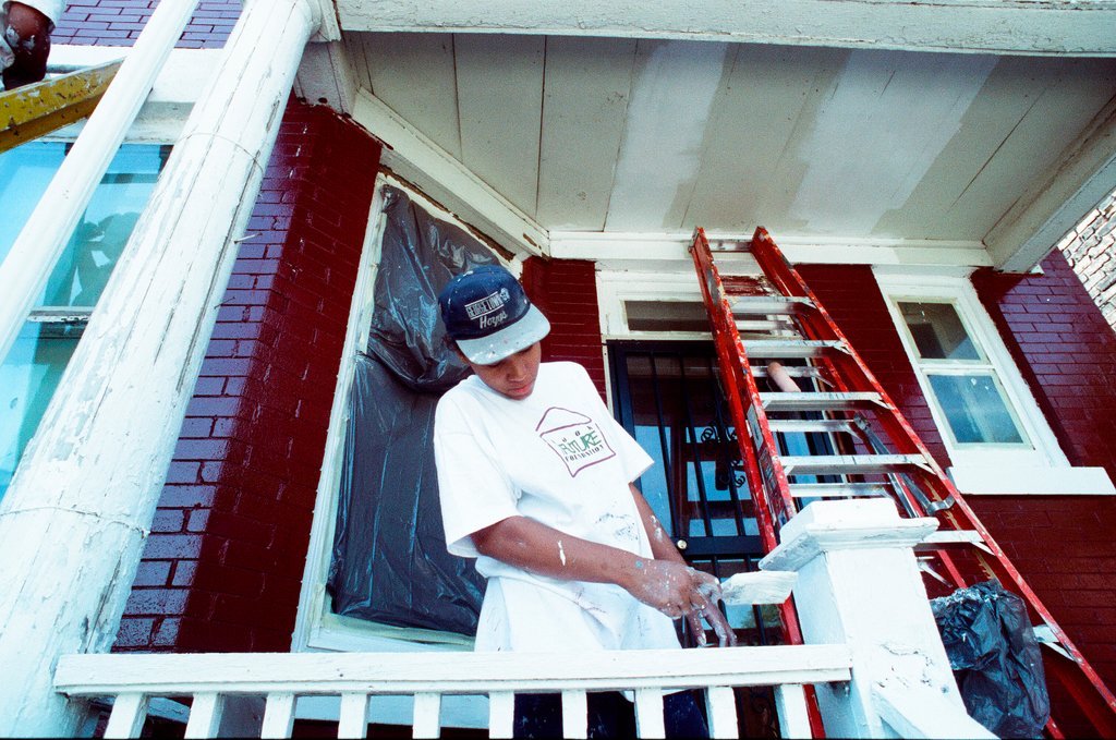 Teens from Look to the Future program paint a porch - Jon Sall for Chicago Sun-Times