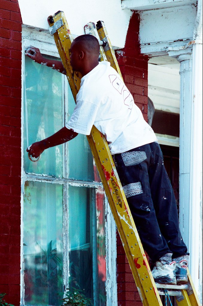 Teens from Look to the Future program paint a porch - Jon Sall for Chicago Sun-Times