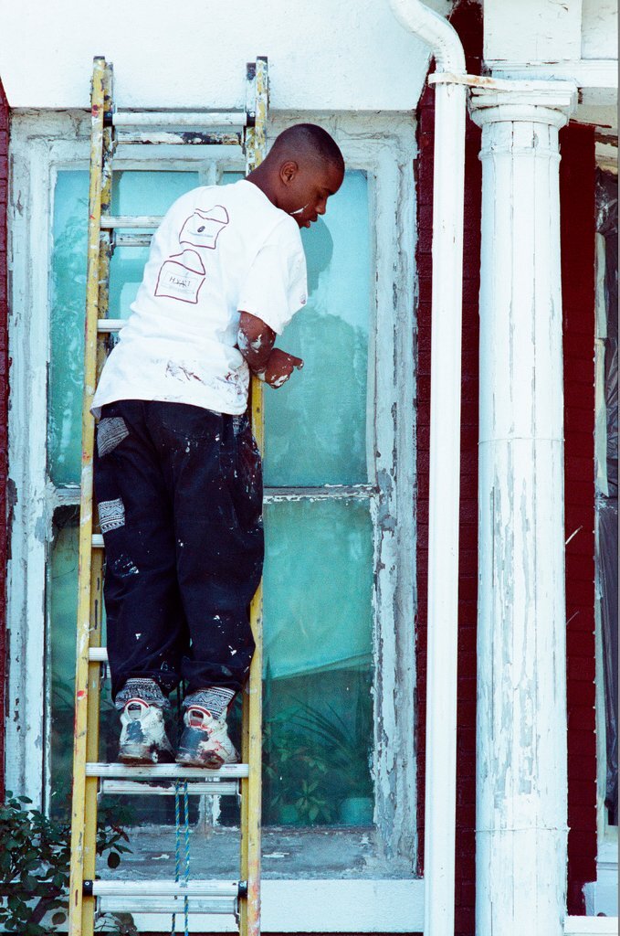 Teens from Look to the Future program paint a porch - Jon Sall for Chicago Sun-Times