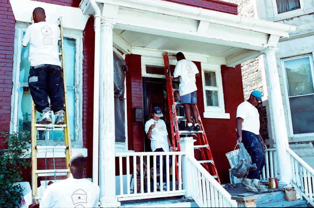 Teens from Look to the Future program paint a porch - Jon Sall for Chicago Sun-Times