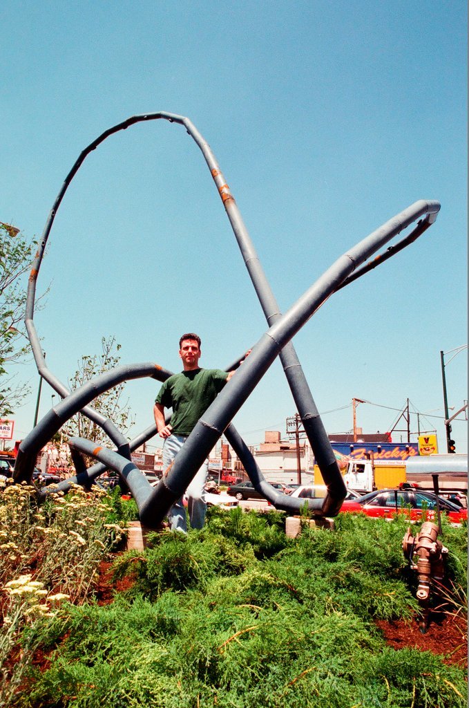 Sculptor Josh Garber with his sculpture, 