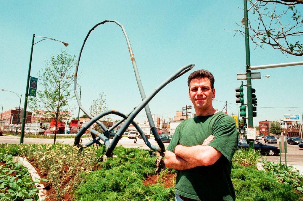 Sculptor Josh Garber with his sculpture, 