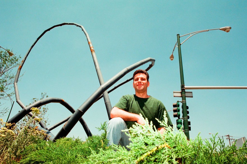 Sculptor Josh Garber with his sculpture, 