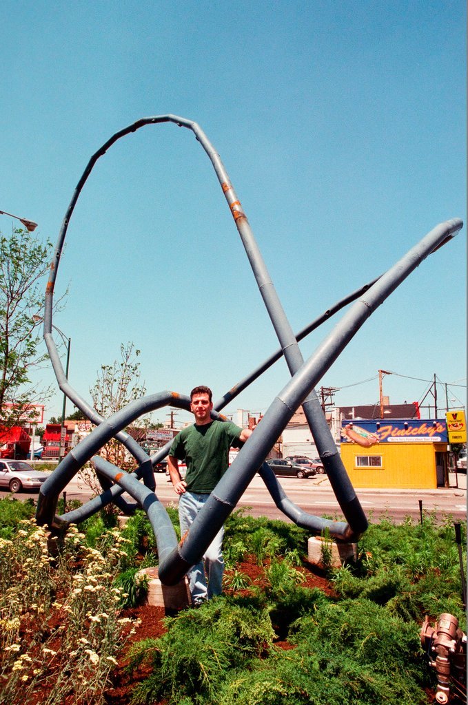 Sculptor Josh Garber with his sculpture, 
