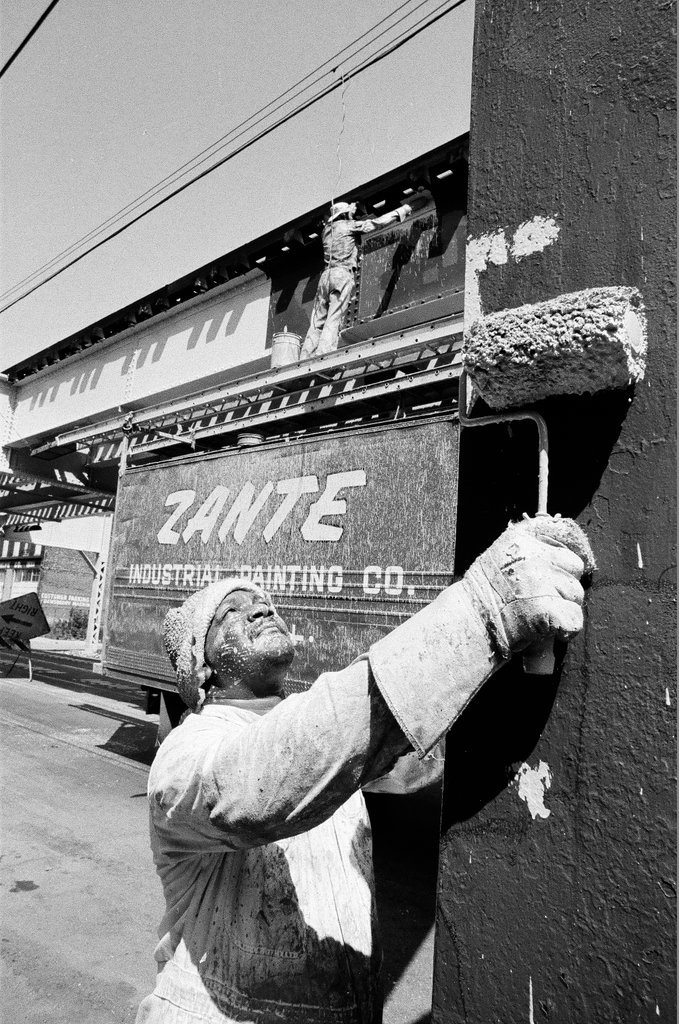 Workers painting elevated train supports - Chicago Sun-Times