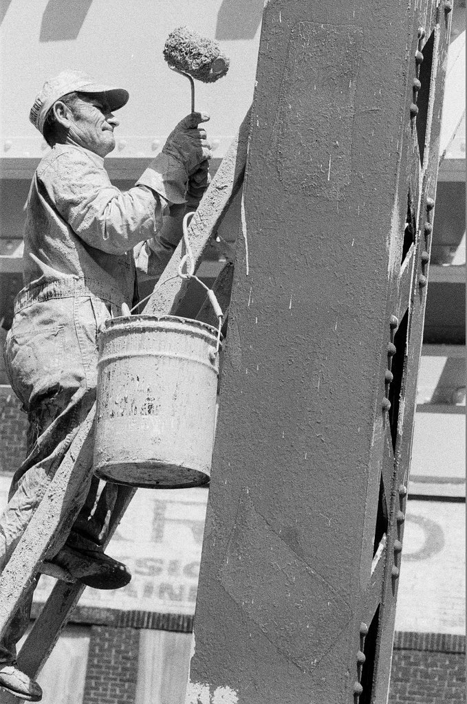 Workers painting elevated train supports - Chicago Sun-Times