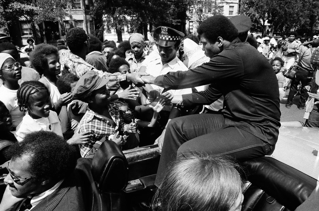 Muhammed Ali rides in car during parade - Chicago Sun-Times