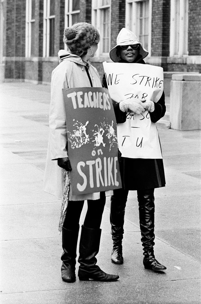 Teachers on strike carry signs outside high school - Chicago Sun-Times