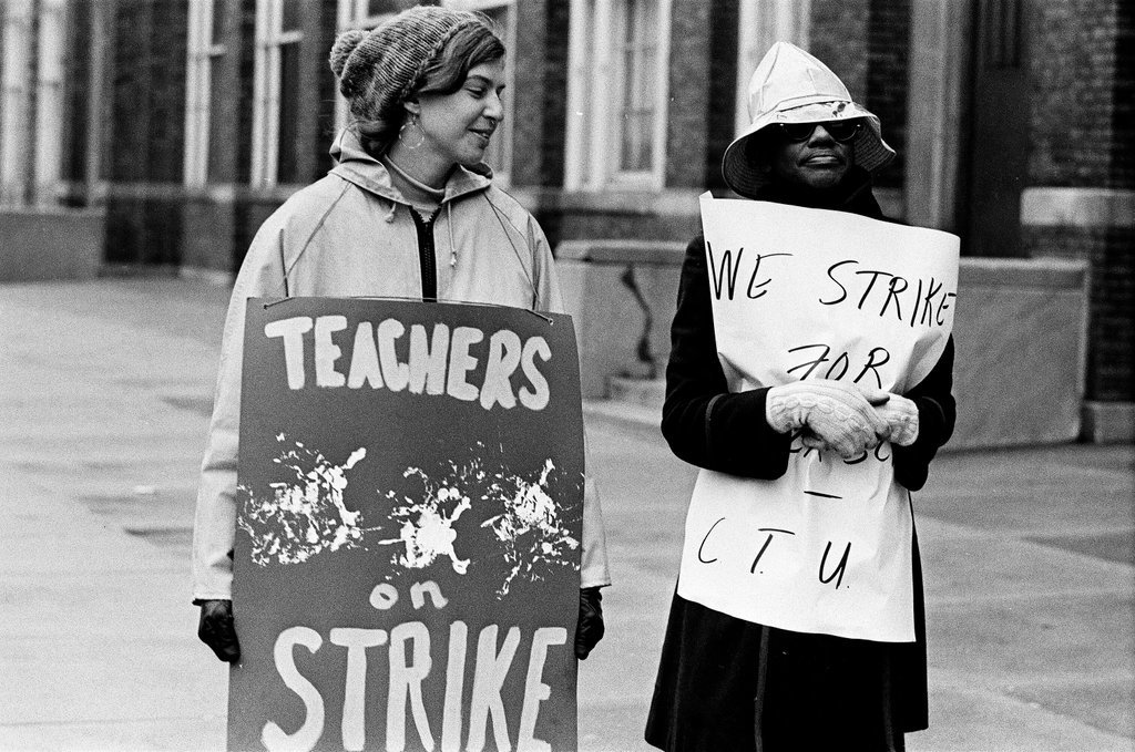Teachers on strike carry signs outside high school - Chicago Sun-Times