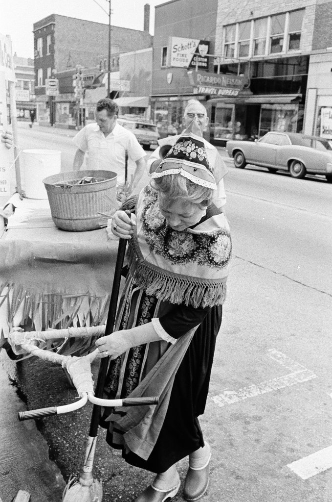 People in Scandinavian costume cleaning sidewalk - Don Burk for Chicago Sun-Times