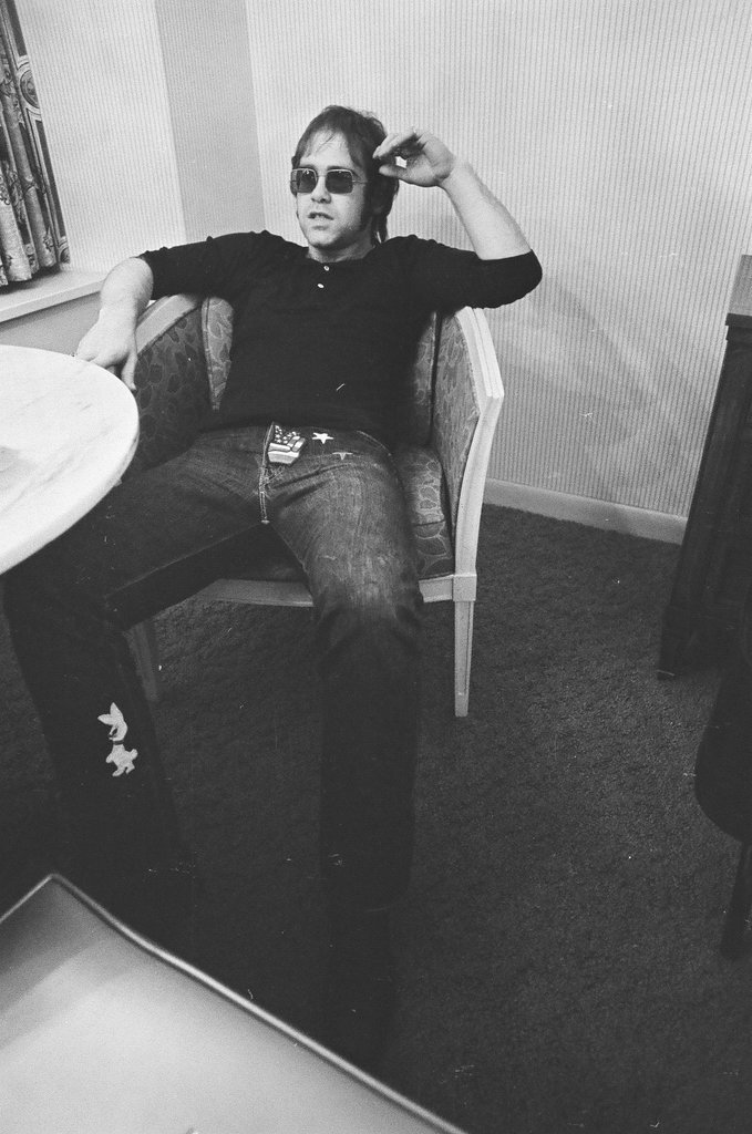 Elton John sits in a chair - Bob (Robert) Black for Chicago Sun-Times