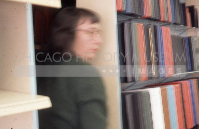 Woman alongside file system - Maier, Vivian