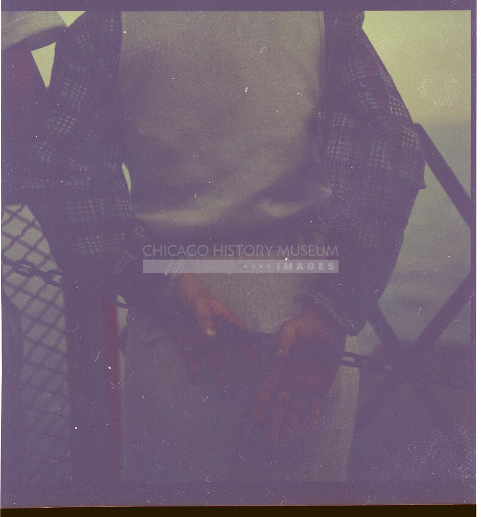Man clasping a fence chain - Maier, Vivian