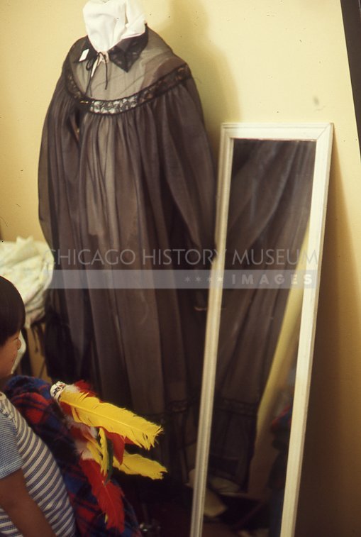 Rummage sale at Kenilworth Union Church, child with housecoat - Maier, Vivian
