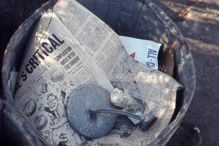 Newspaper in a garbage can - Maier, Vivian