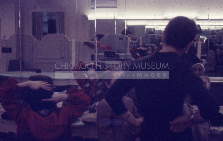 Young women trying on hats - Maier, Vivian