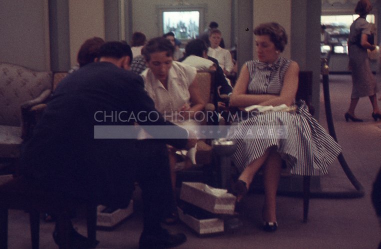 Women being fitted for shoes - Maier, Vivian