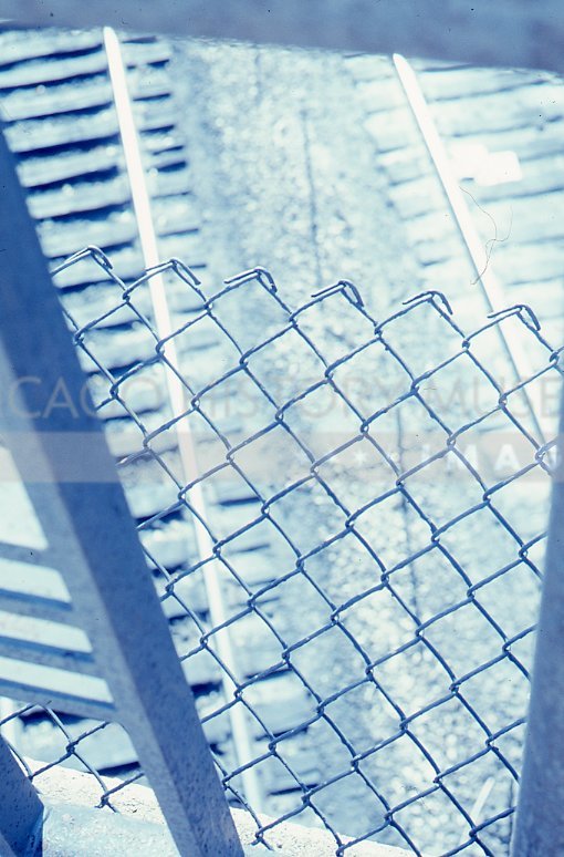 Railroad tracks through fence - Maier, Vivian