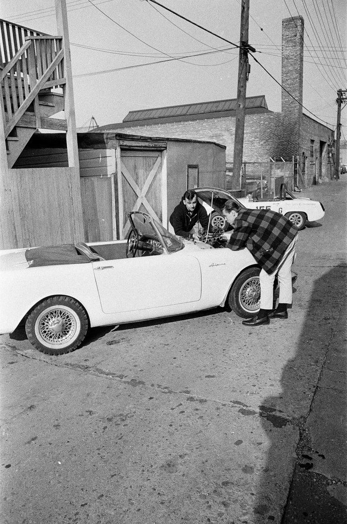 George Westlund sands a car - John Tweedle for Chicago Sun-Times