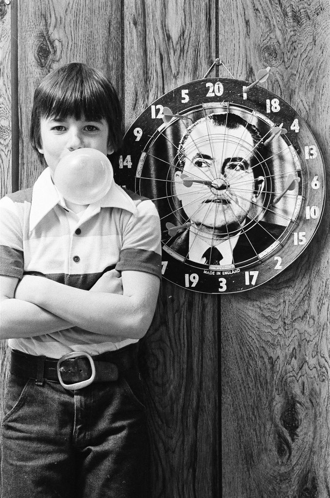 Boy throws darts at Richard Nixon dart board - Gene Pesek for Chicago Sun-Times