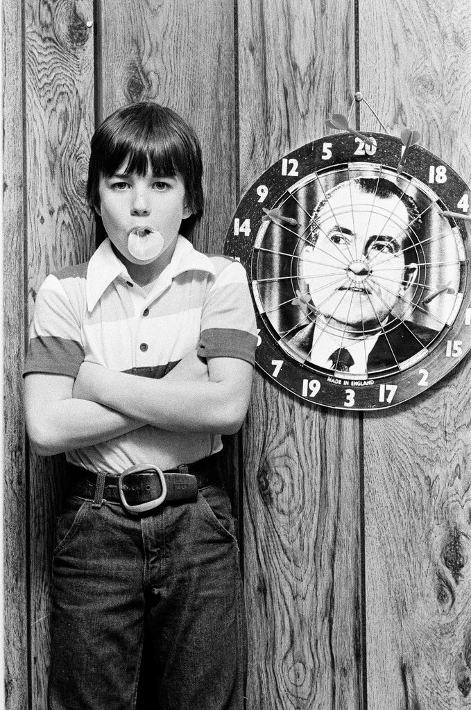 Boy throws darts at Richard Nixon dart board - Gene Pesek for Chicago Sun-Times