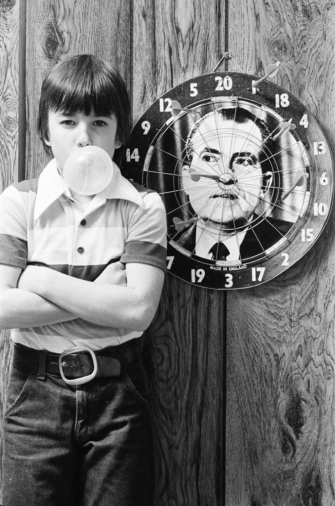 Boy throws darts at Richard Nixon dart board - Gene Pesek for Chicago Sun-Times
