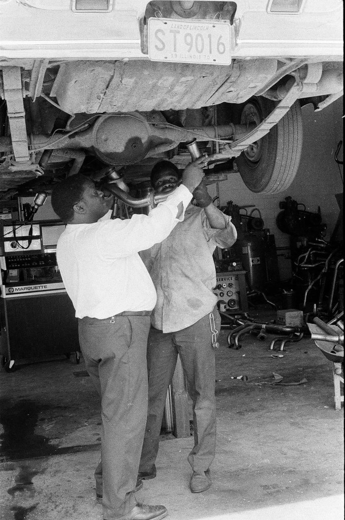 Car technicians work on vehicle - Mickey Rito for Chicago Sun-Times