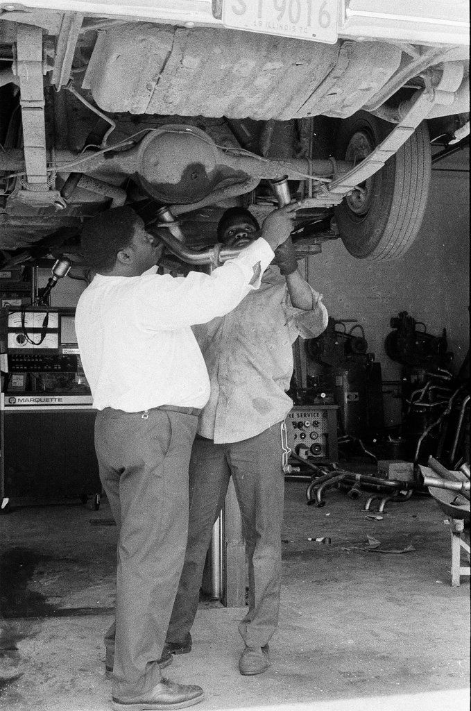 Car technicians work on vehicle - Mickey Rito for Chicago Sun-Times