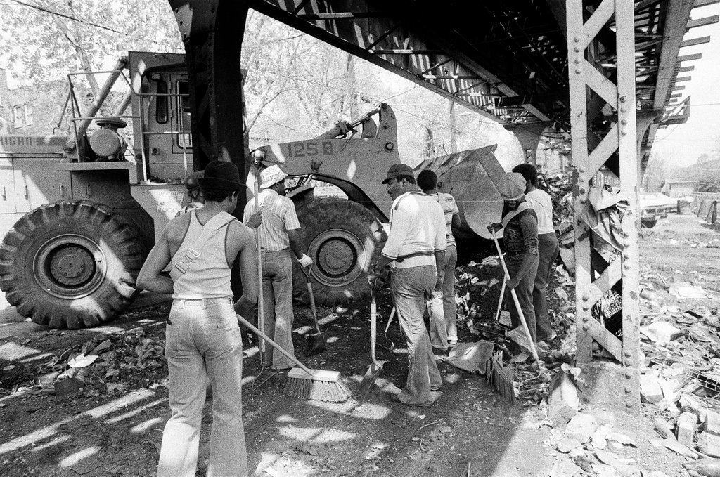 City sanitation workers clear garbage under 
