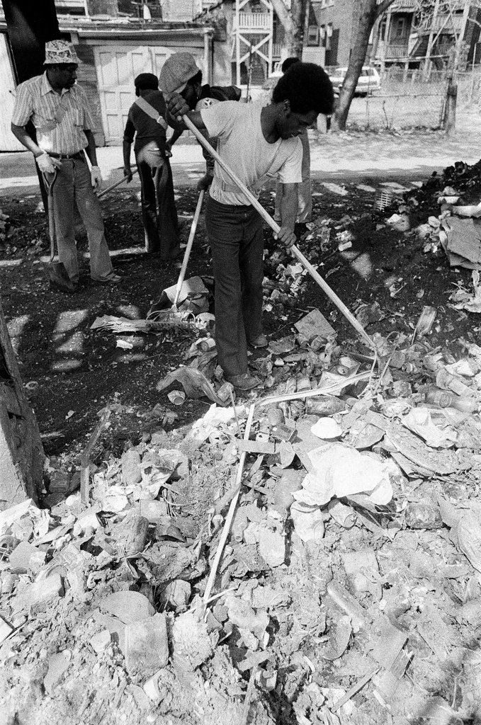 City sanitation workers clear garbage under 