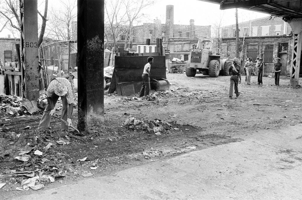 City sanitation workers clear garbage under 