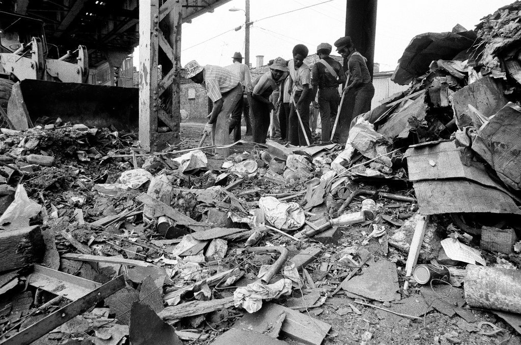 City sanitation workers clear garbage under 