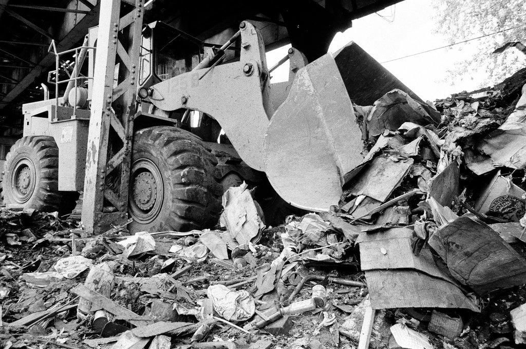 City sanitation workers clear garbage under 